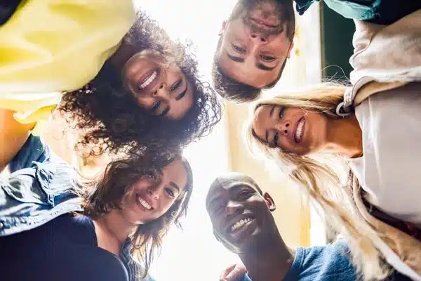 group in huddle facing downward