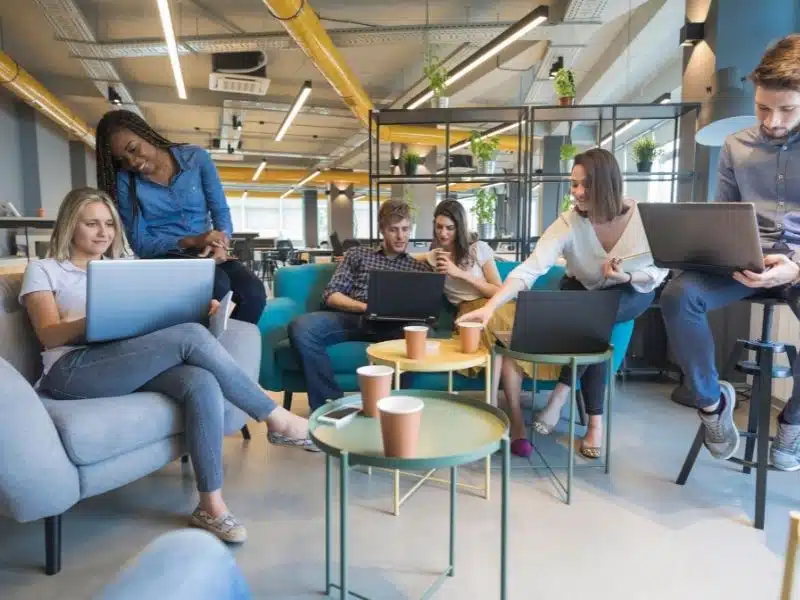 A group of people sitting on couches working together